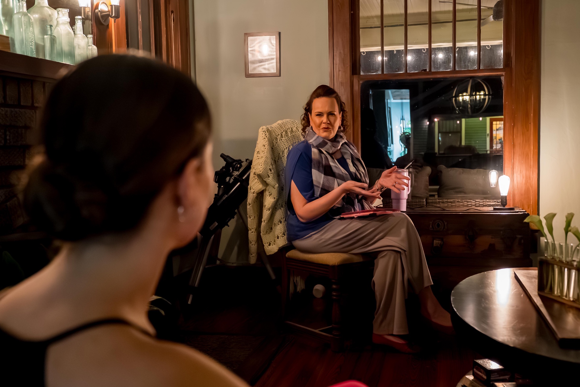 Performer speaking with a guest across a St. Petersburg living room