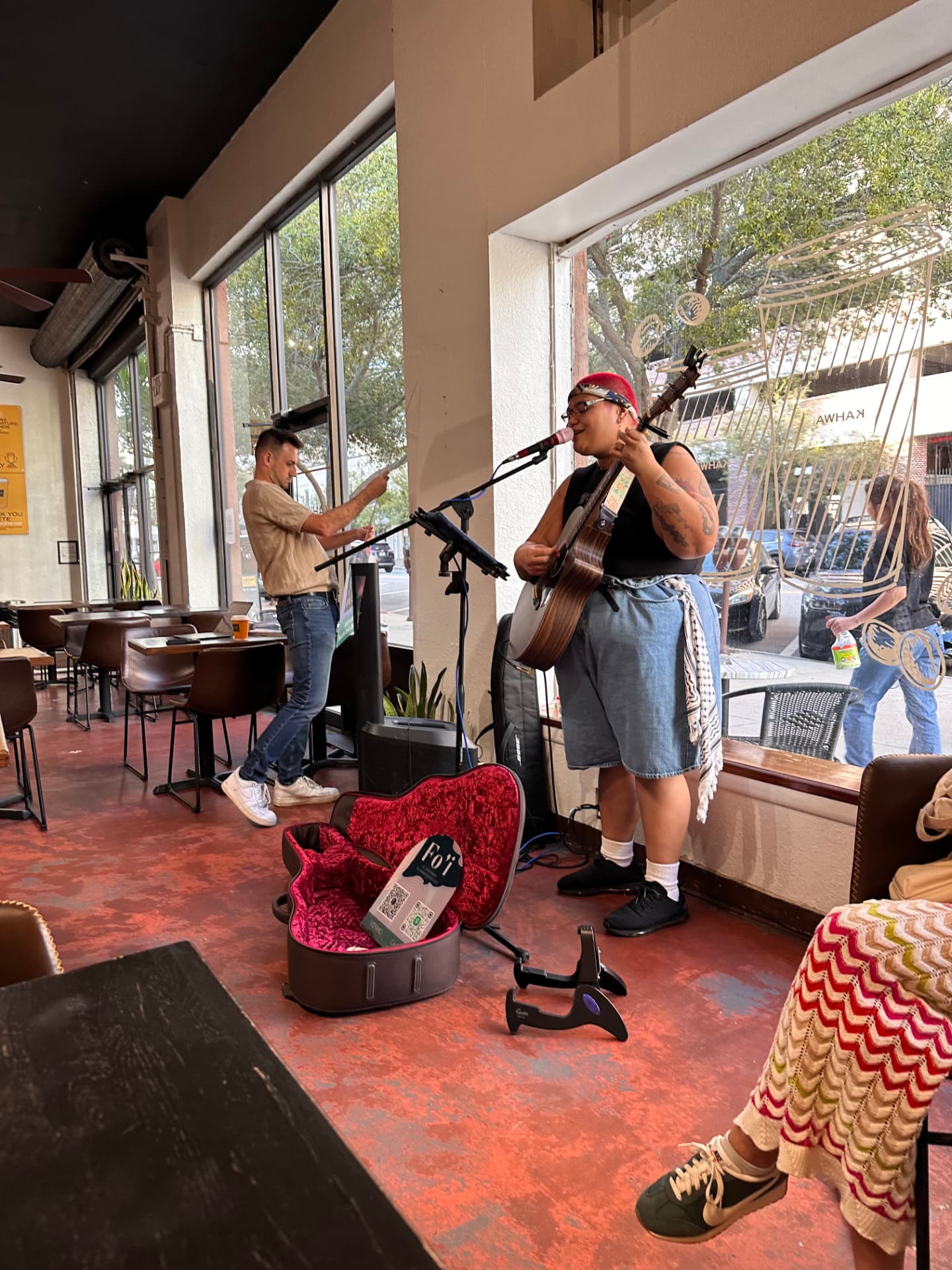 Musician performing for a cafe audience at a Story Keepers event