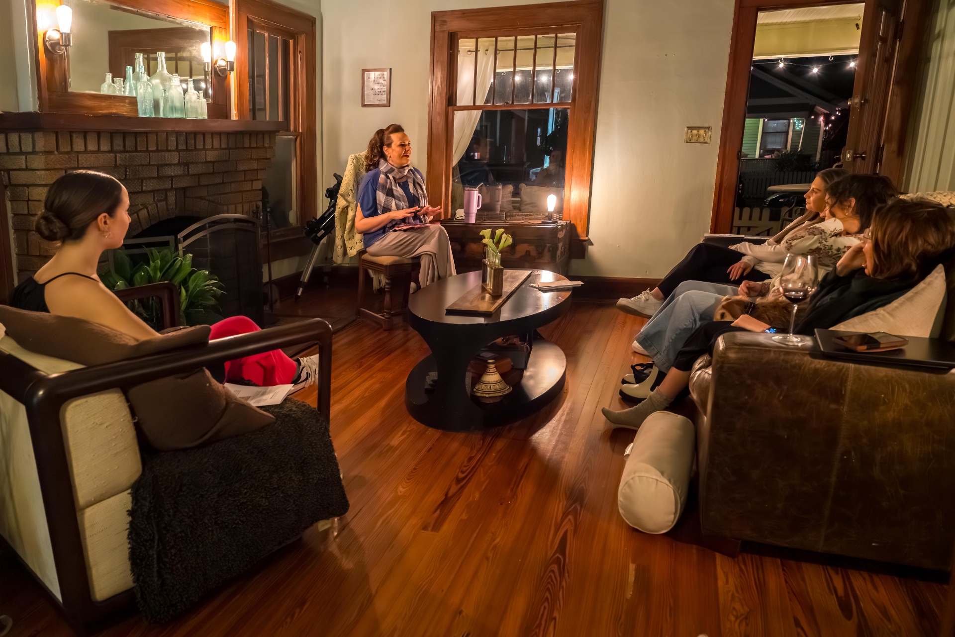 Audience seated a few feet from the performer during a living-room show